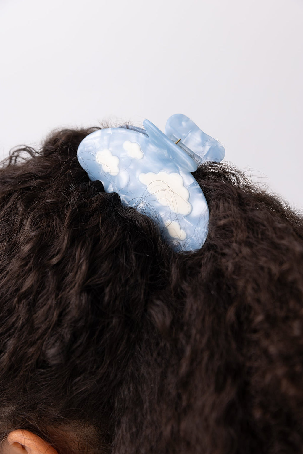 Lucy Hair Claw Blue Sky Clouds